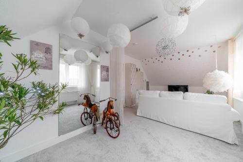 a white living room with a bike in it at Privatapartment in Laatzen