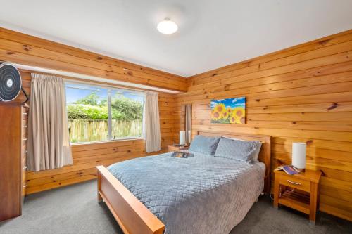 a bedroom with a bed and a window at Piece of Paradise - Turangi Holiday Home in Turangi