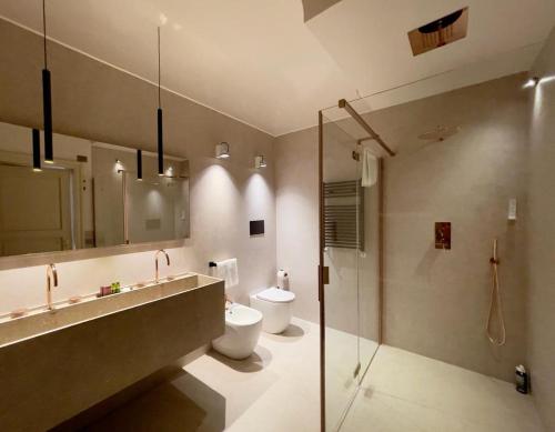 a bathroom with a sink and a toilet and a shower at Villa Favorita Hotel & Events in Marsala