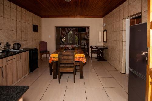 a kitchen and dining room with a table and chairs at Invite Guest House - Self Catering Accommodation in Vanderbijlpark in Vanderbijlpark