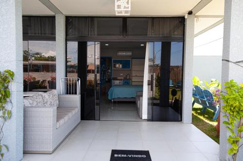 a glass door of a house with a bedroom at Pousada Guaricana in Pontal do Paraná