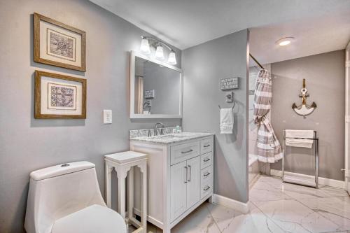 a bathroom with a toilet and a sink and a mirror at Sunset Coral in Myrtle Beach