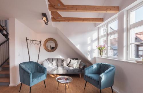 a living room with two chairs and a couch at St. Salvator Apartments in Fulda