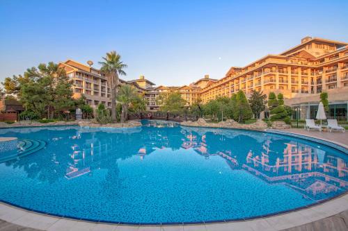 a large swimming pool in front of a resort at Amara Luxury Resort & Villas in Kemer