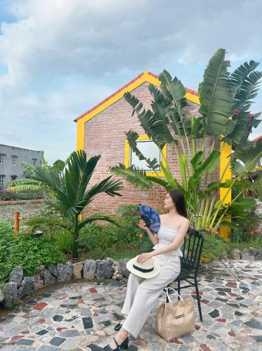 a woman sitting in a chair holding a frisbee at Ninh Binh Royal Homestay in Ninh Binh