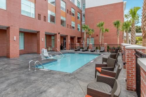 a courtyard with a swimming pool in front of a building at Cambria Hotel Mount Pleasant - Charleston in Charleston