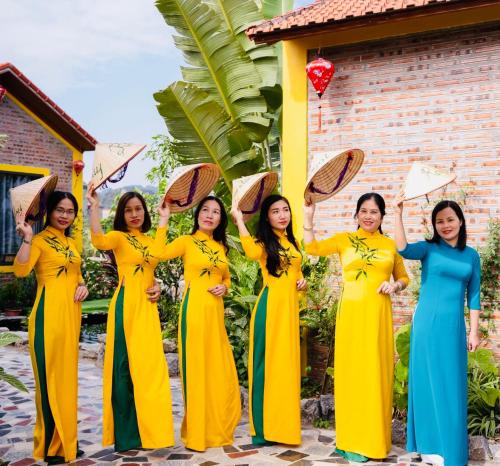 a group of women standing in front of a house at Ninh Binh Royal Homestay in Ninh Binh