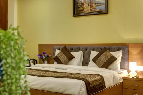Postel nebo postele na pokoji v ubytování Hotel TMS Grand