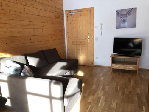 a living room with a couch and a flat screen tv at Haus Annabelle in Wagrain