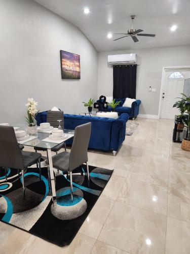 a living room with a blue couch and a table at The Hide Away in Nassau