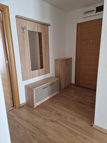 a bathroom with a mirror and a wooden door at Gondola Neda Lux in Zlatibor