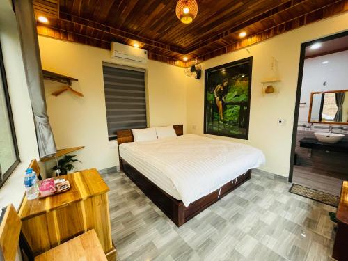 a bedroom with a bed and a bathroom with a sink at Ninh Binh Royal Homestay in Ninh Binh