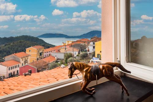 a toy horse is standing on a window sill at Casa Monella in La Spezia