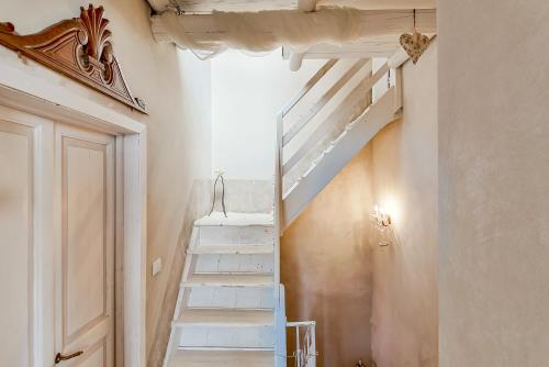 a white staircase in a room with a door at Casa Monella in La Spezia