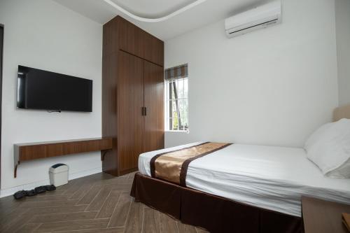 Ένα ή περισσότερα κρεβάτια σε δωμάτιο στο Nhà Nghỉ Ngọc Anh