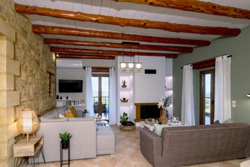 a living room with a couch and a stone wall at Stone villa Halepa panoramic view, private pool,big garden & quiet in Néon Khoríon