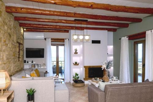 a living room with a couch and a fireplace at Stone villa Halepa panoramic view, private pool,big garden & quiet in Néon Khoríon