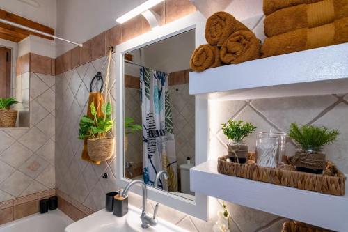 a bathroom with a sink and a mirror and towels at Stone villa Halepa panoramic view, private pool,big garden & quiet in Néon Khoríon