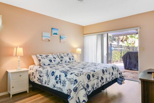 a bedroom with a bed and a sliding glass door at Village Green Oasis in Bradenton