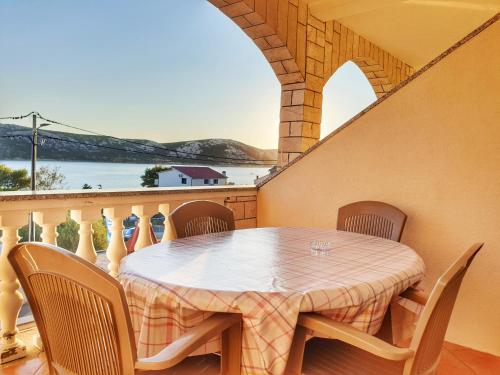 a table on a balcony with a view of the water at BetaNovalja in Novalja