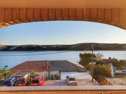 a group of cars parked in a parking lot near a body of water at BetaNovalja in Novalja