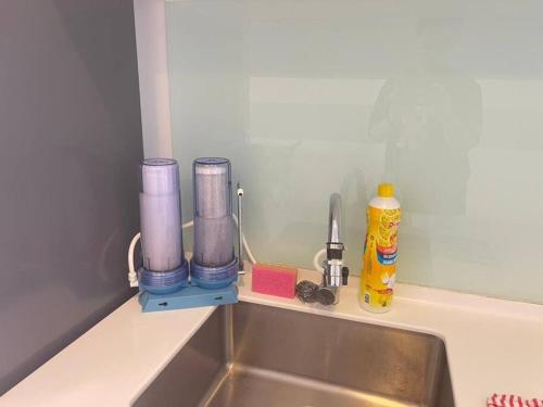 a kitchen counter top with a sink and a counter top with a sink at Teega Suites Seaview by VDO Homestay in Nusajaya