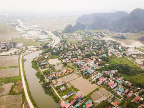 an aerial view of a village next to a river at Ninh Binh Royal Homestay in Ninh Binh