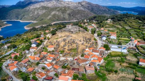 an aerial view of a town on a hill with a castle at Hotel O Guerreiro in Ponte da Barca