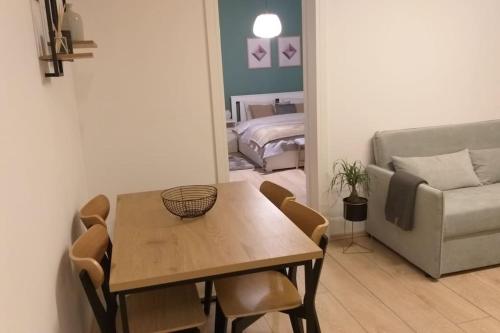 a living room with a table and a couch at White brick Apartment in Zagreb