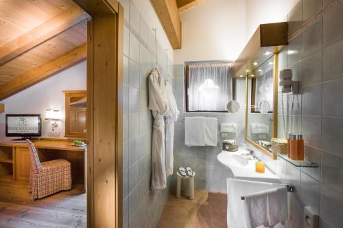 a bathroom with a sink and a mirror at Bio Hotel Hermitage in Madonna di Campiglio