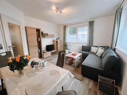 a living room with a couch and a table at Ferienwohnung zum Schreckenberg in Annaberg-Buchholz