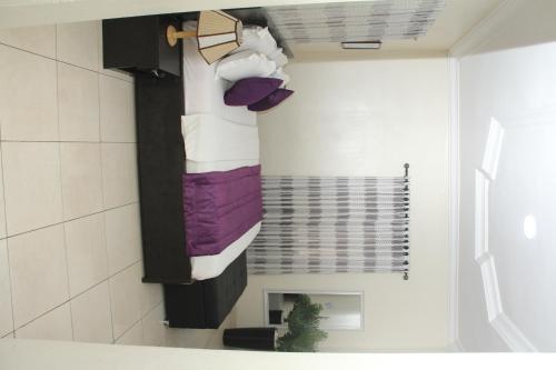 a bathroom with a towel rack in a room at J Gibson suite in Lekki