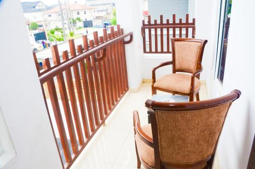 two chairs sitting on a balcony with a window at J Gibson suite in Lekki