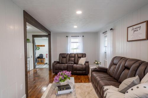 a living room with a couch and two chairs at Farmhouse of Blessings in Dundee