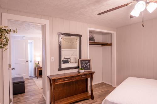 a bedroom with a bed and a mirror at Farmhouse of Blessings in Dundee