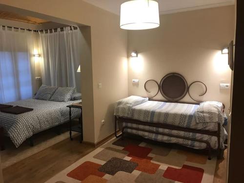 a bedroom with two beds and a mirror on the wall at Casa Mirador de Entrepeñas in Guadalajara