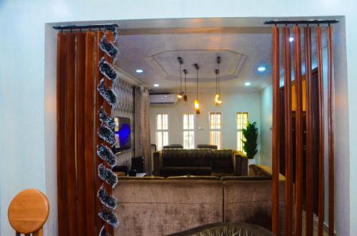 a reflection of a living room with a couch in a mirror at J Gibson suite in Lekki