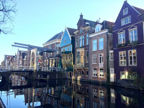 a group of buildings next to a canal at Vakantiehuis Achter de Duinen in Castricum