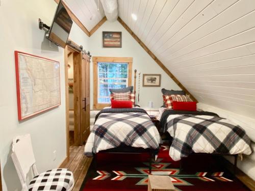 a room with two beds in a attic at Black Bear Cabin 2 in Whitefish