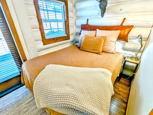 a bedroom with a bed in a log cabin at Black Bear Cabin 3 in Whitefish
