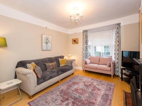 a living room with a couch and a chair at Pass the Keys 3 Storey Townhouse in Shrewsbury