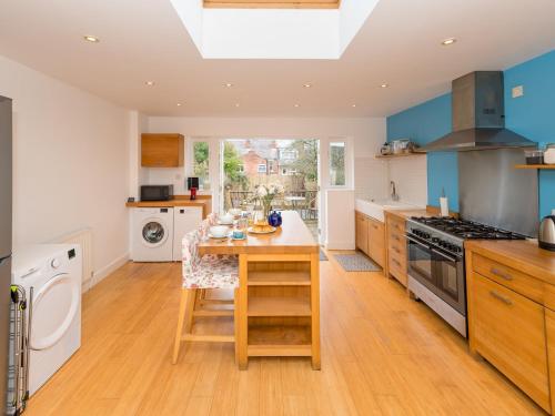 a kitchen with a table and a stove top oven at Pass the Keys 3 Storey Townhouse in Shrewsbury