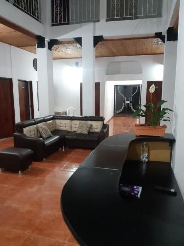 a living room with a table and a couch at Hotel Lili Popayán - Sede 2 in Popayan