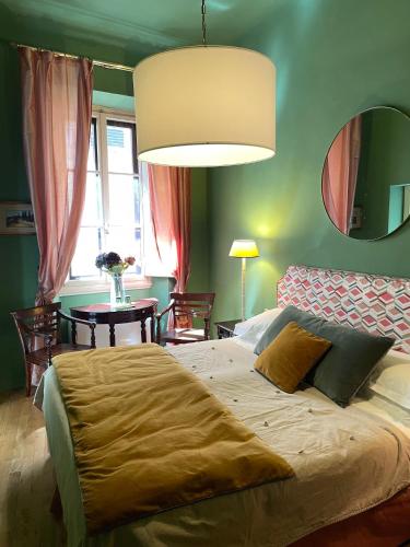 a bedroom with a large bed and a table at Residenza dei Pucci in Florence