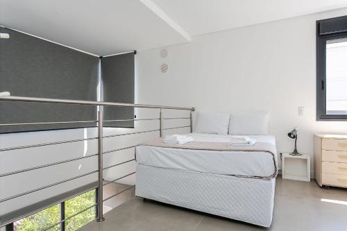 um quarto branco com uma cama e uma janela em Duplex com churrasqueira a 200m da praia #JA21 em Florianópolis