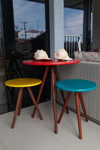 two tables and two chairs with hats on top of them at Pousada Guaricana in Pontal do Paraná