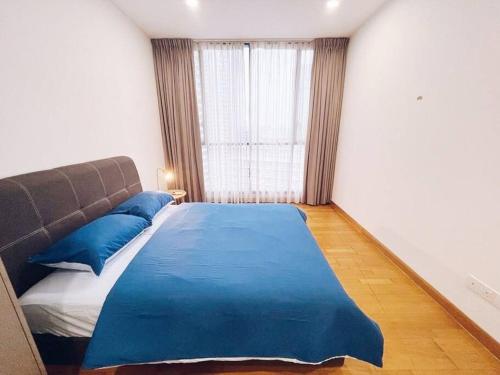a bedroom with a blue bed and a window at [PROMO]Connected train 2 Bedroom ABOVE MALL (22) in Kuala Lumpur