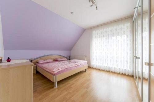 a bedroom with a bed and a large window at Private House in Hannover