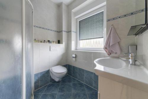 a bathroom with a toilet and a sink and a shower at Private House in Hannover