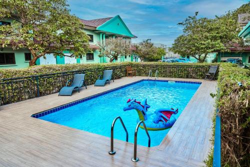 a swimming pool with two dolphins painted on it at ADA - Granite Court in Accra